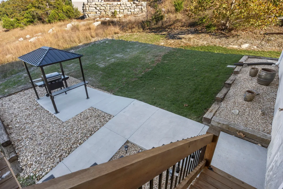 An inviting landscaped outdoor area with a charming gazebo and grill, perfect for intimate gatherings or quiet relaxation. The gazebo offers a spot to enjoy sunset views in a tranquil setting, reinforcing the idea of outdoor seclusion and romantic ambiance.